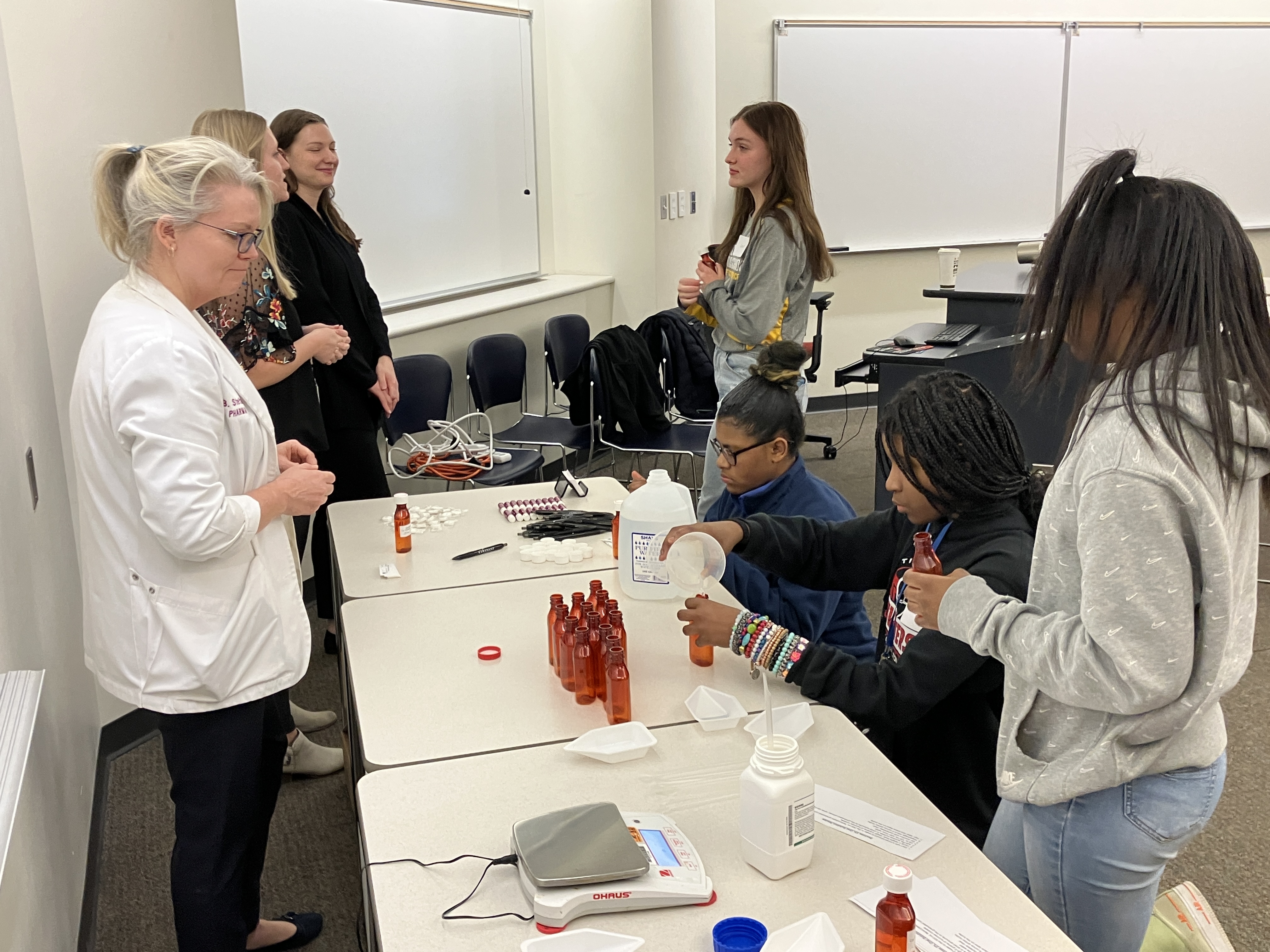 Students learn how to make a sugar solution.